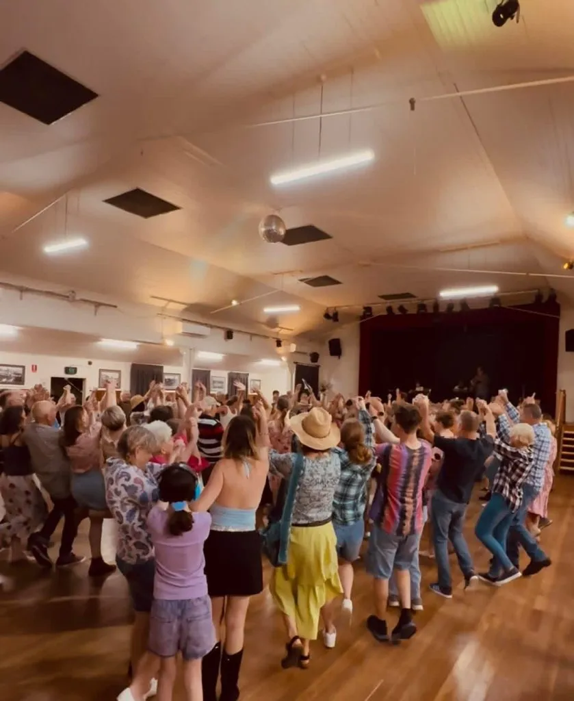 Families at a movie night in the Palmwoods hall