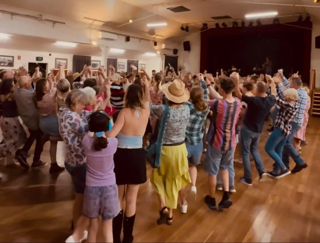 Community members dancing together at the Palmwoods hall